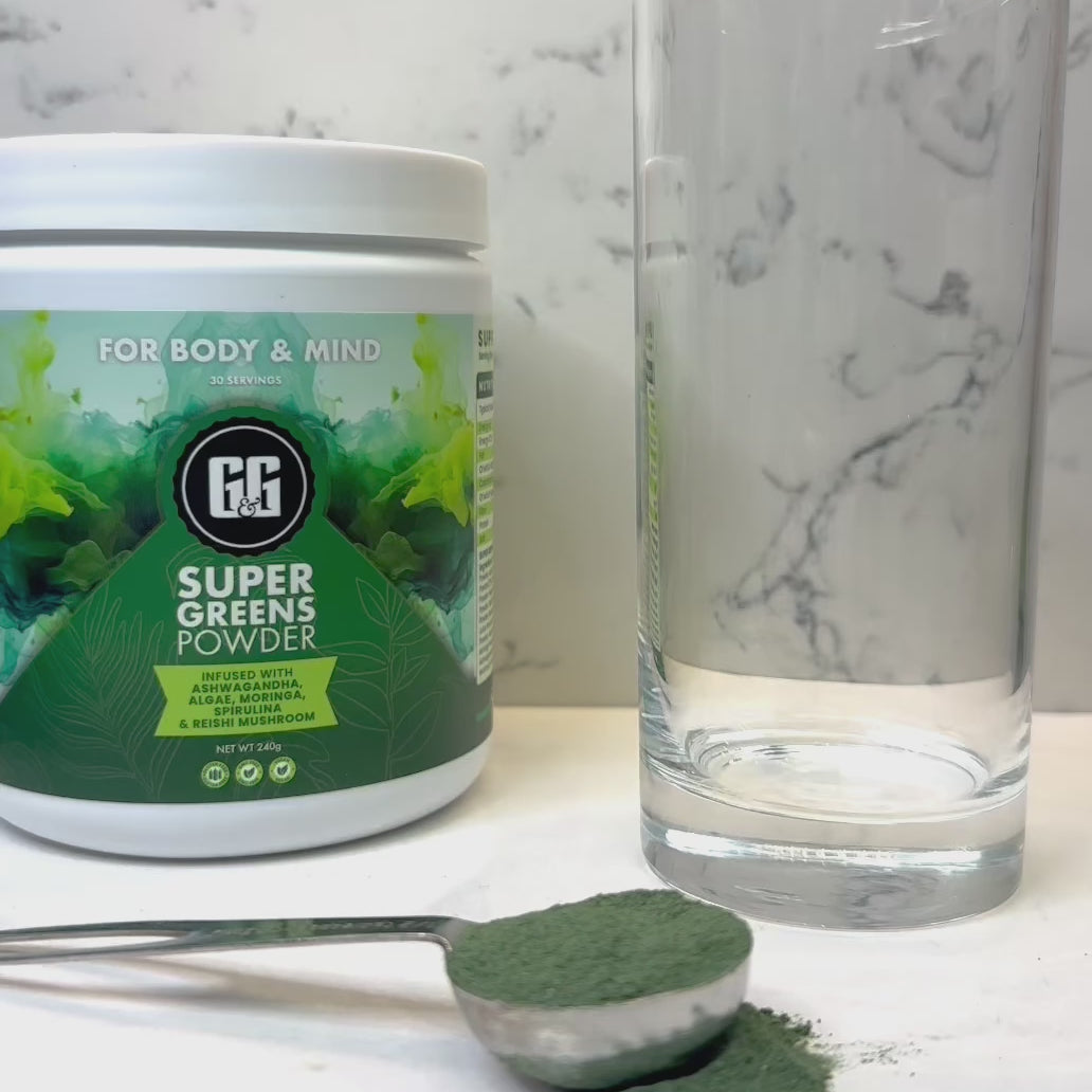 Pouring G&G super greens powder into glass