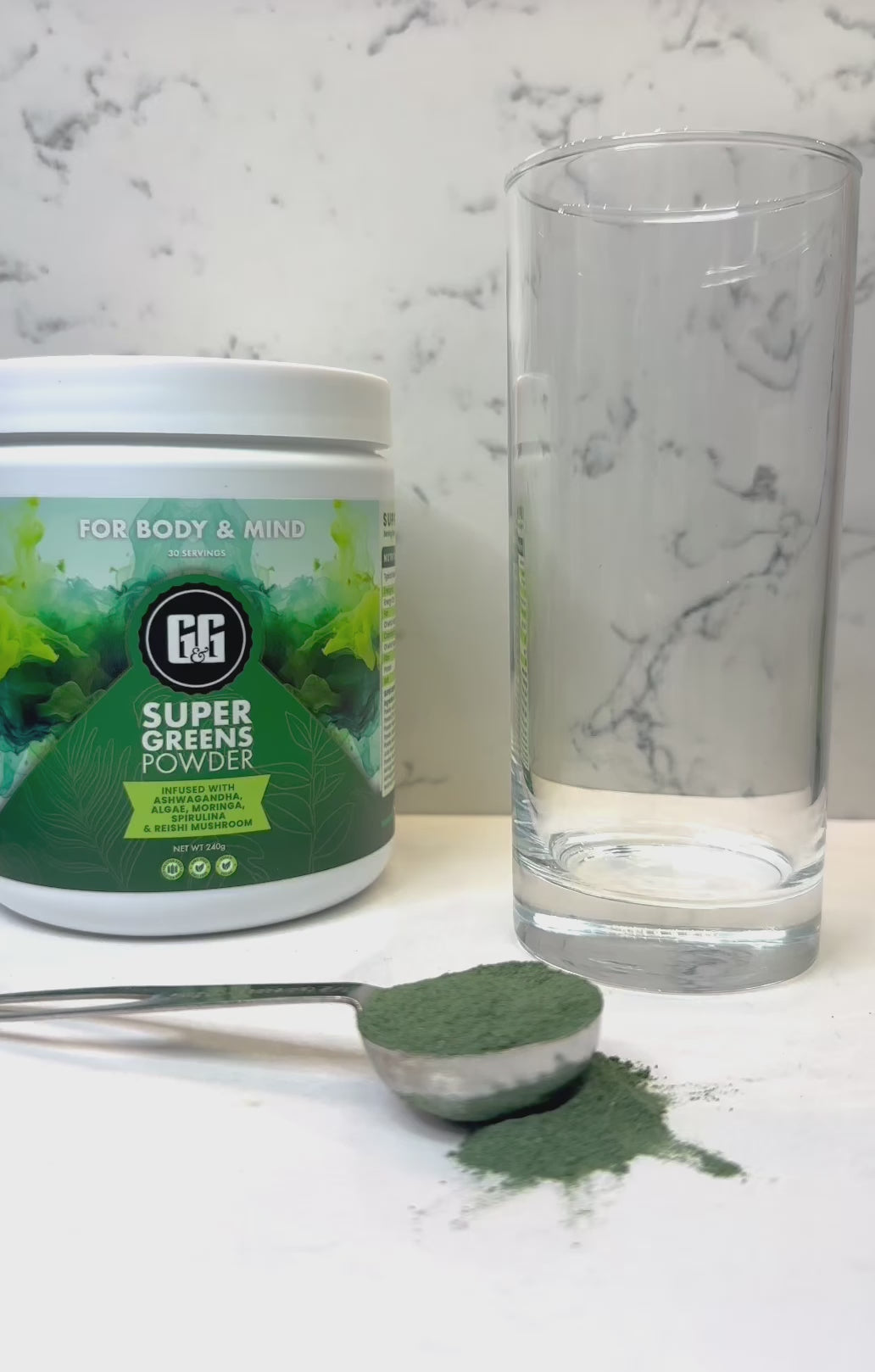 Pouring G&G super greens powder into glass